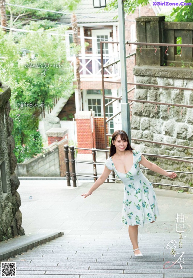 A woman in a white dress is walking down some steps.