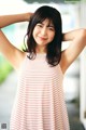 A woman in a red and white striped dress posing for a picture.